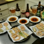 Tempura vegetables laid out with sauces and beers